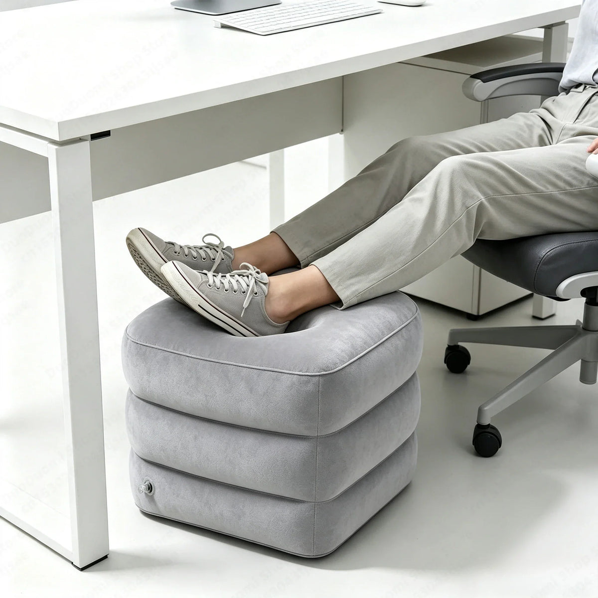 Grey inflatable footrest under a desk for office comfort