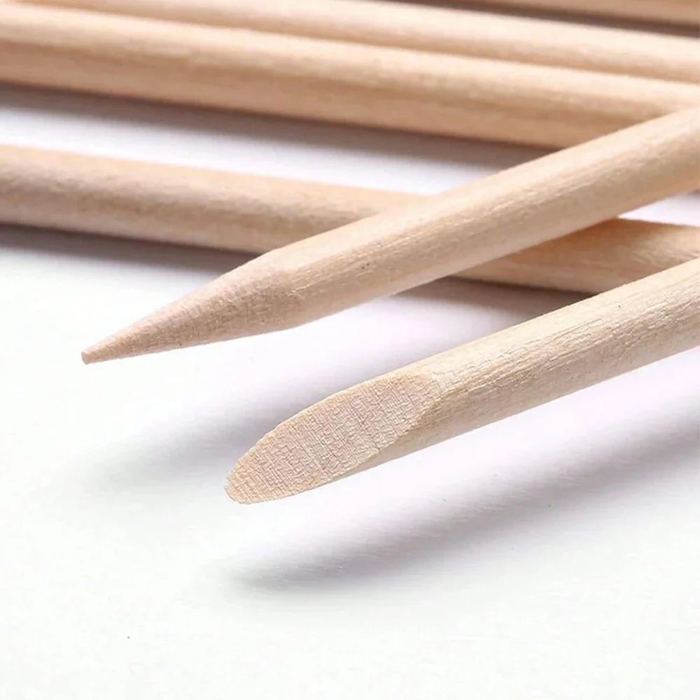 Detailed view of the sharp and slanted flat tips of wooden manicure sticks