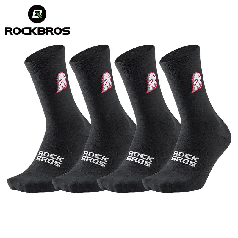 Four pairs of black cycling socks with pixel art dinosaur graphics