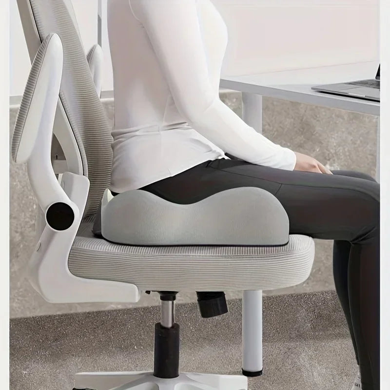 Person sitting on an ergonomic memory foam cushion on an office chair