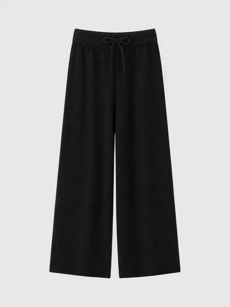 Flat lay of high waisted black knit wide leg pants with a drawstring elastic waist
