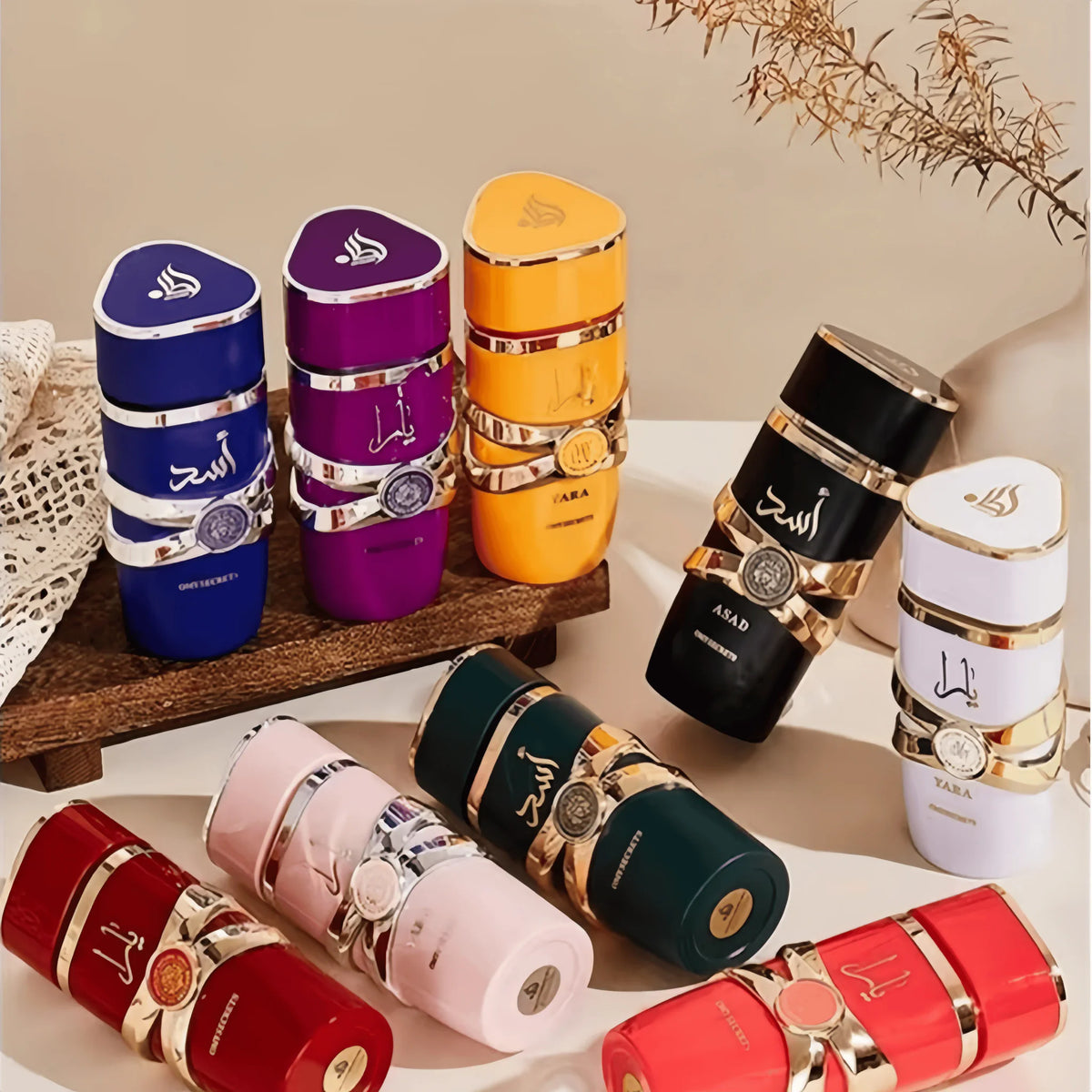 A collection of various colored perfume bottles in a decorative arrangement on a wooden surface.