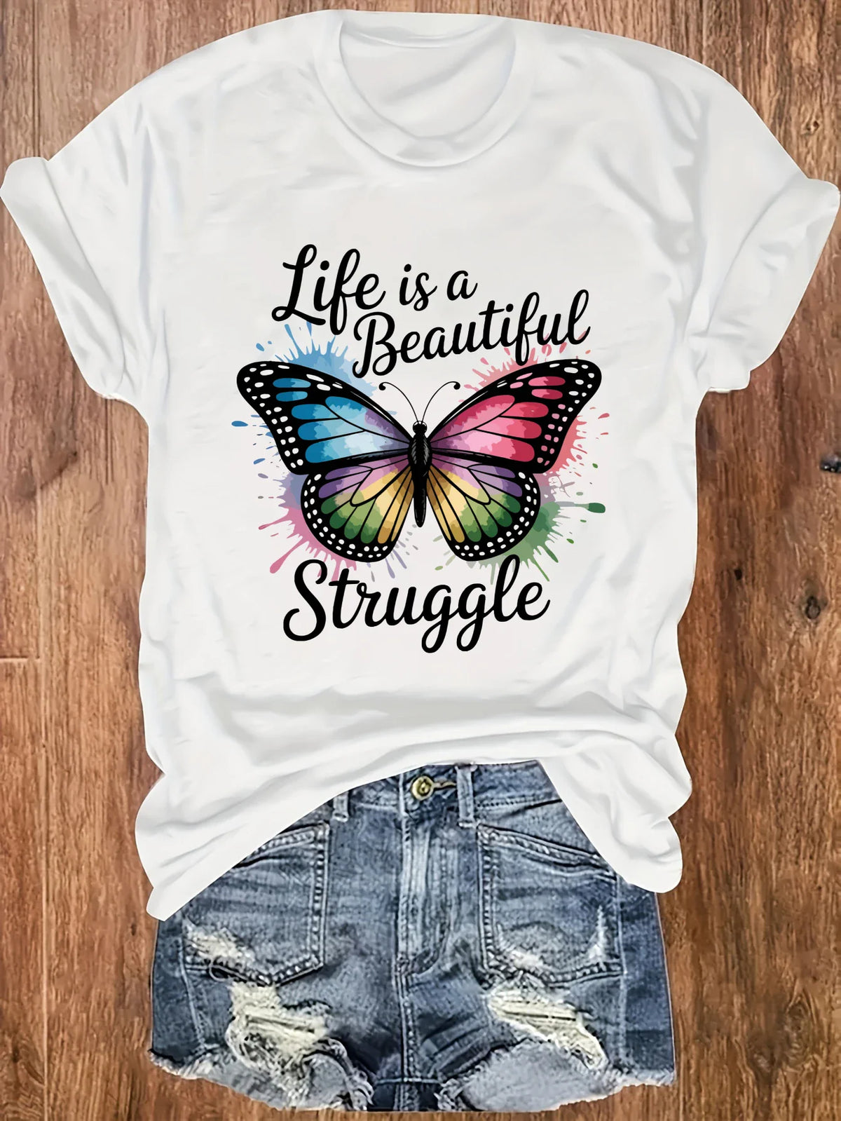 White t-shirt with a colorful butterfly graphic and the text Life is a Beautiful Struggle