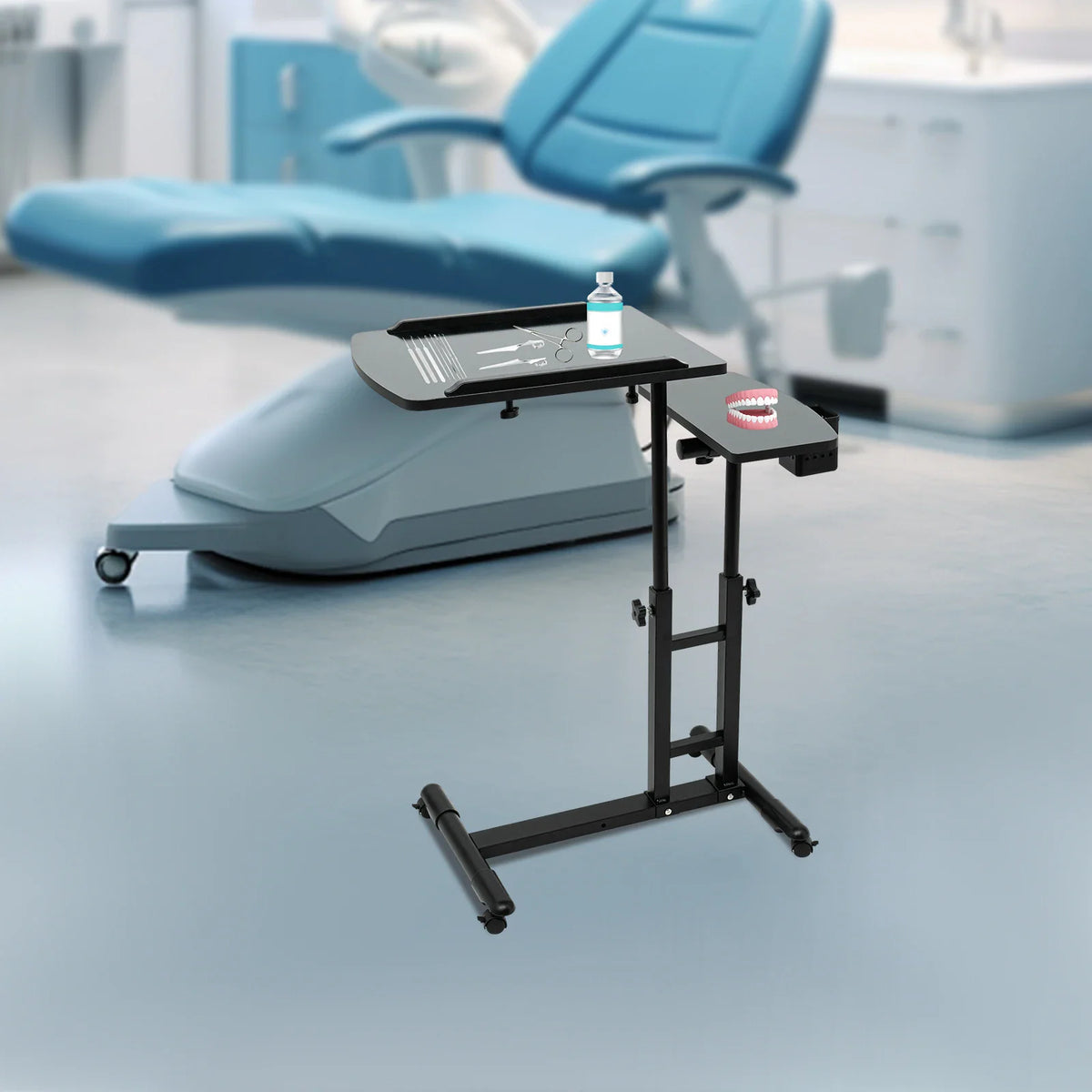 Portable tattoo workstation table with dental tools and model teeth in a dental clinic setting