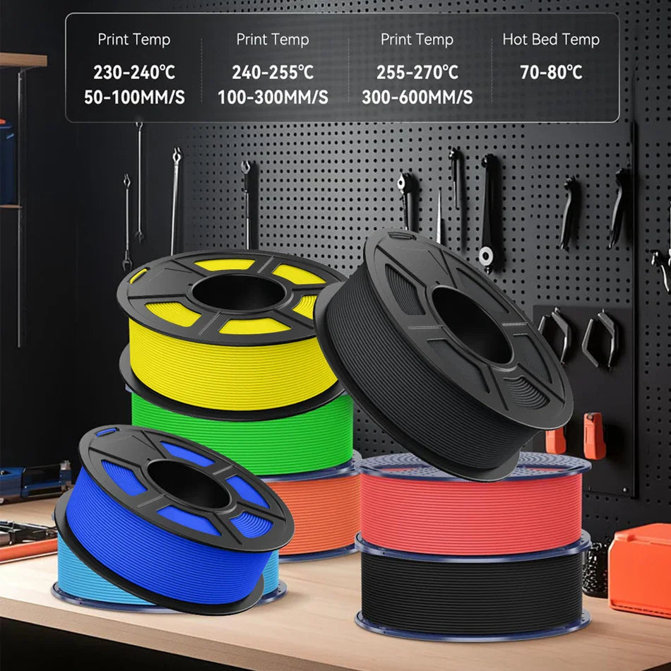 Multiple spools of colorful PETG 3D printer filament stacked on a workbench with workshop tools in the background