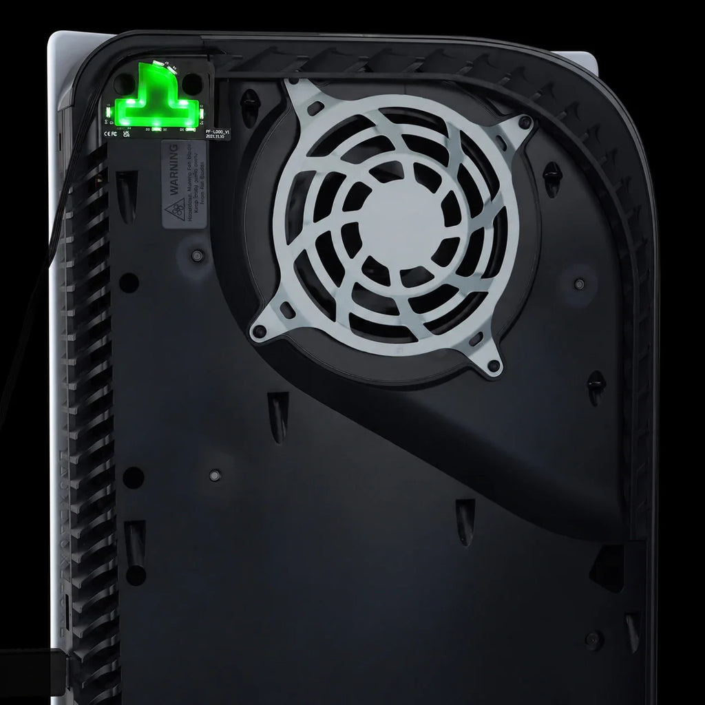 Internal view of a console with green illuminated RGB LED logo light kit installed next to the cooling fan.