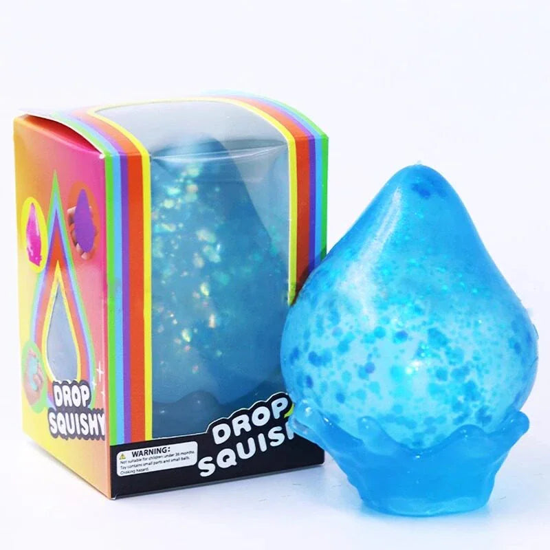 A single blue glittery water-drop squishy toy next to its rainbow-colored retail packaging box