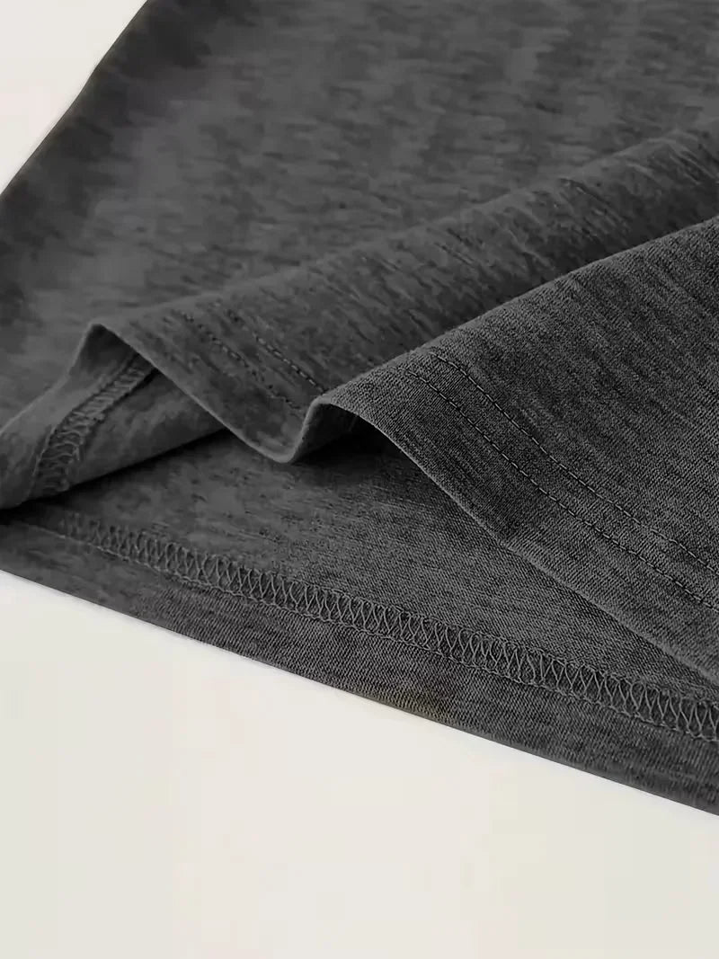 Close-up of the bottom hem of a dark grey short-sleeved t-shirt