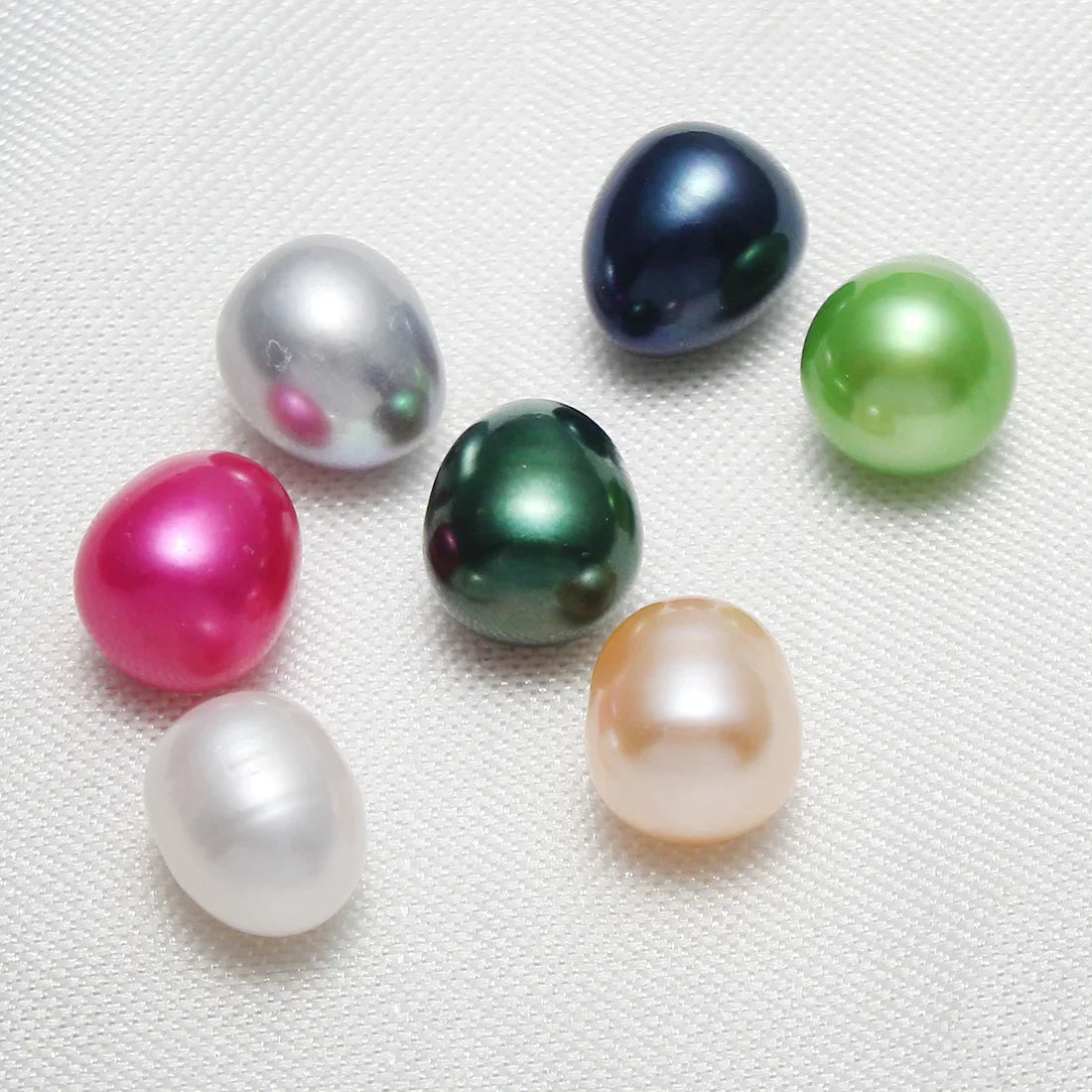 A collection of colorful oval freshwater pearls in various shades