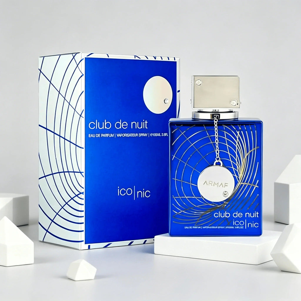 Blue perfume bottle and box displayed with white geometric cube decorations.