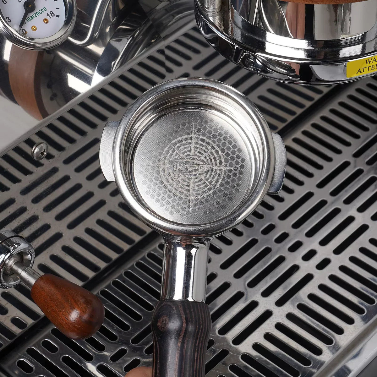 Espresso filter basket inserted into a wooden handle portafilter on a coffee machine