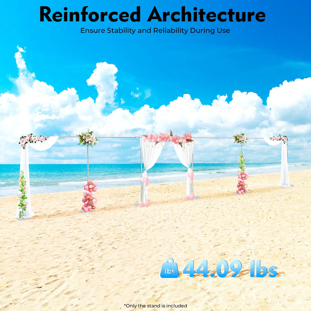 Long wedding arch backdrop decorated with flowers and curtains on a sandy beach