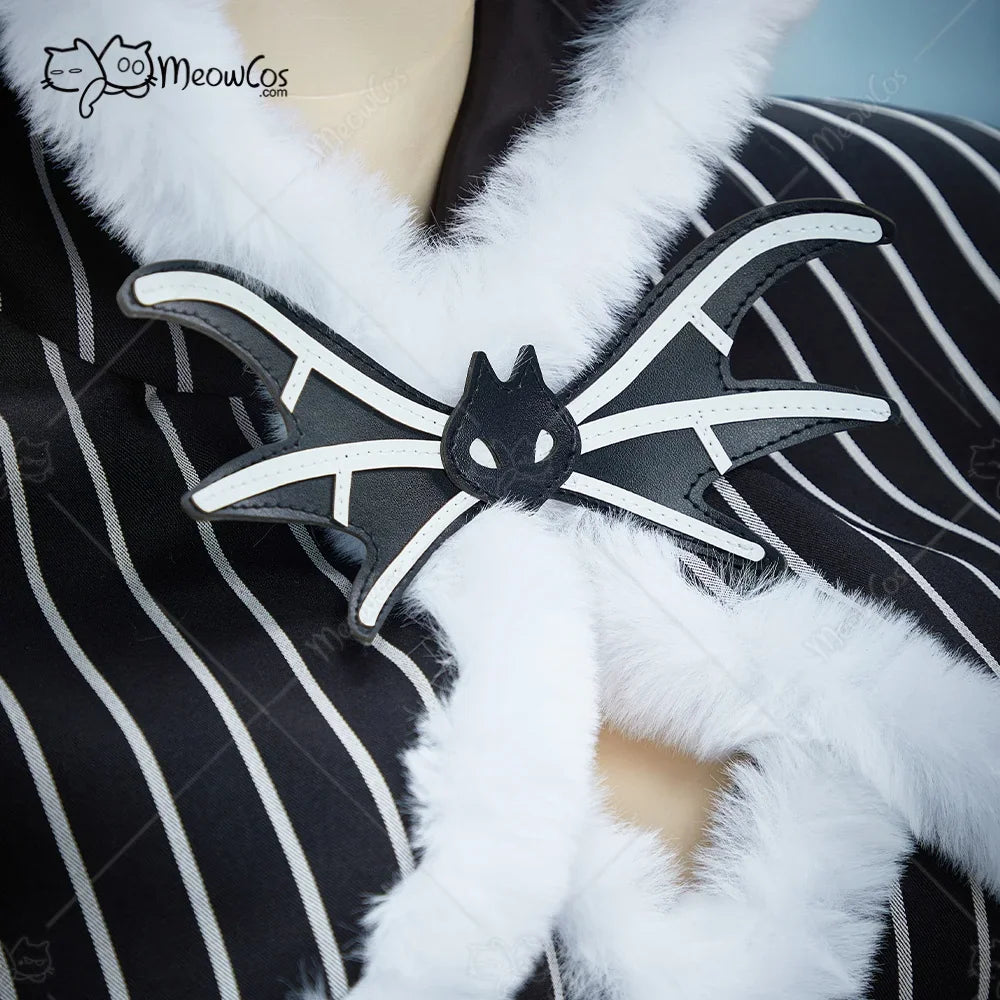Close-up of a decorative bat-shaped bow tie on a striped gothic costume
