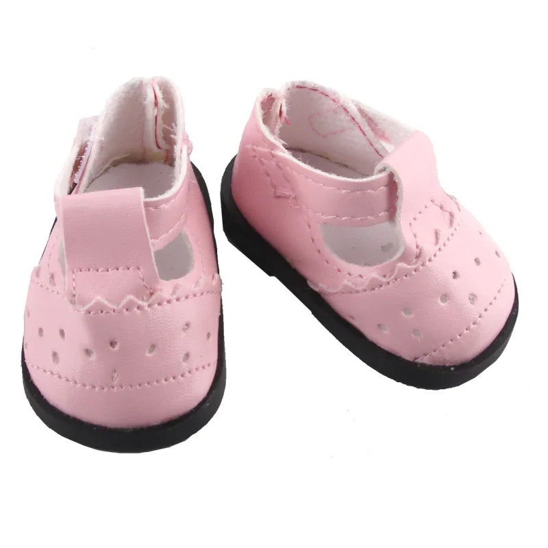 Pink doll shoes with a T-strap design and perforated details