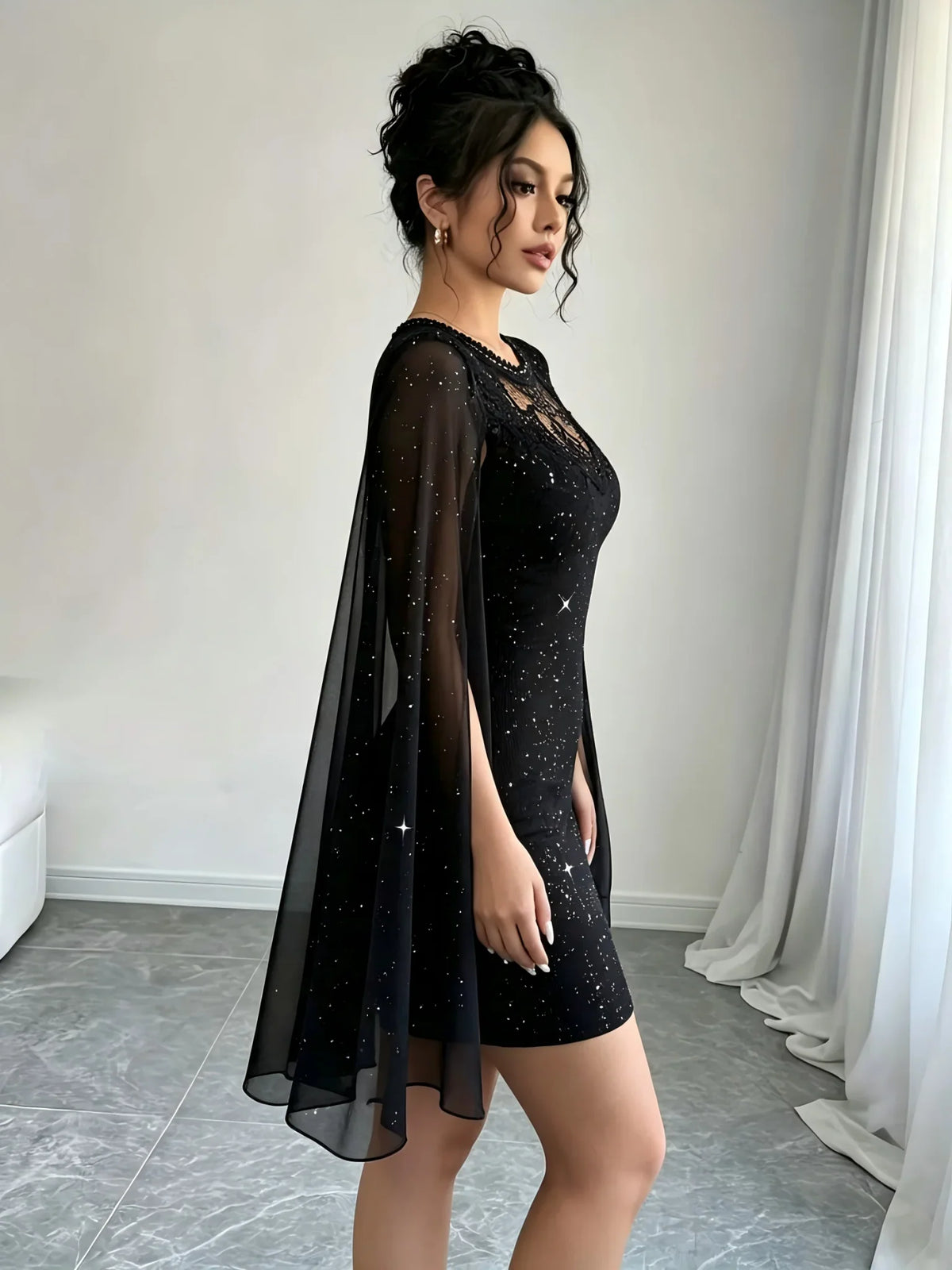 Side profile view of a black glittery bodycon mini dress with sheer cape sleeves