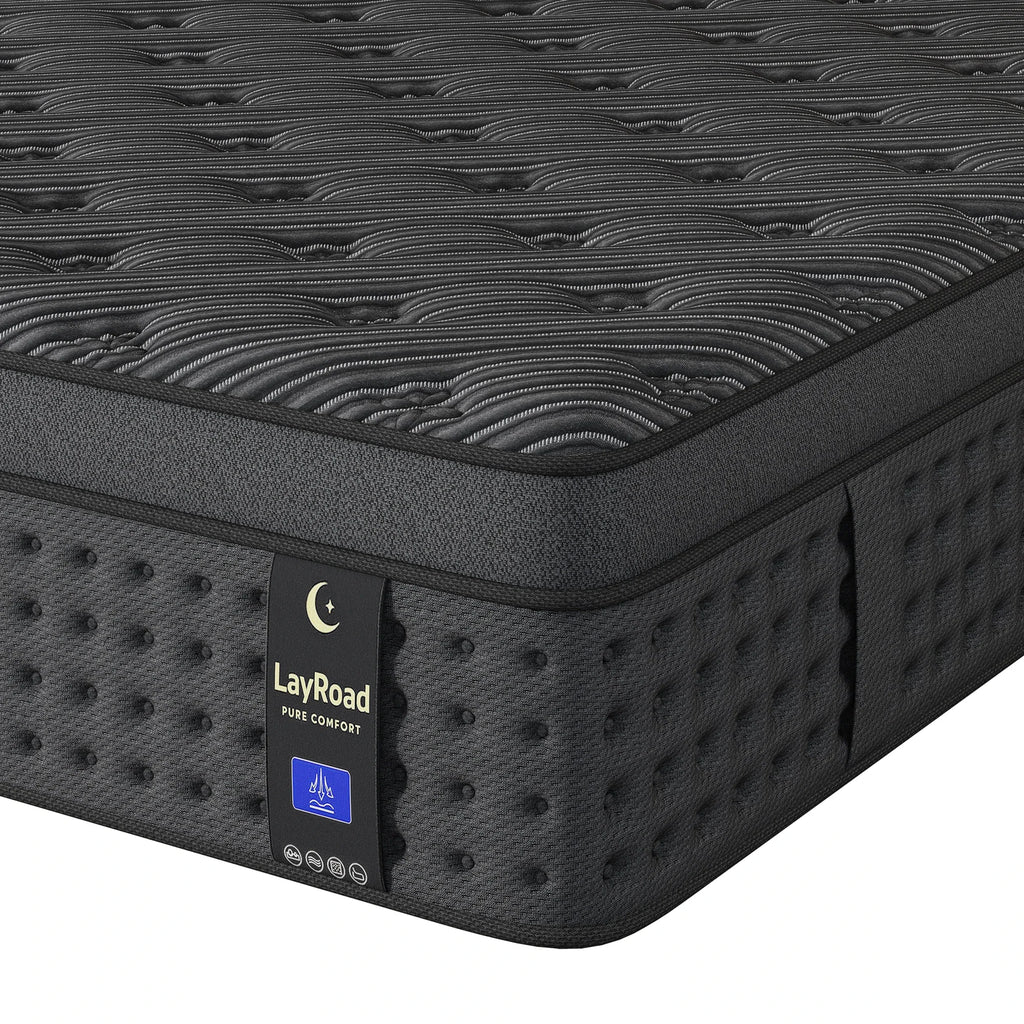 A close-up of a charcoal-grey hybrid mattress with a textured quilted top and dark side panels.