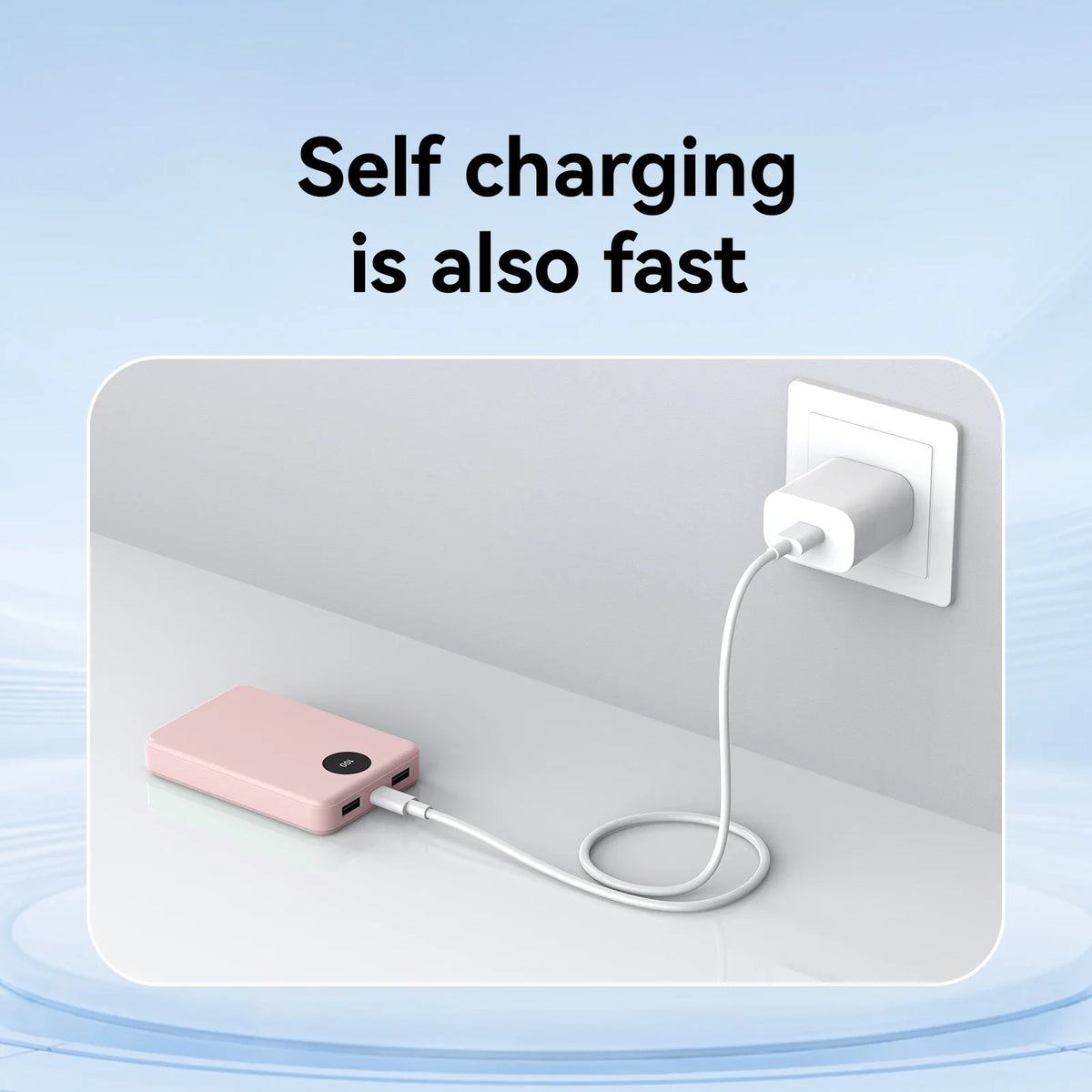 A pink portable power bank being charged by a wall adapter.