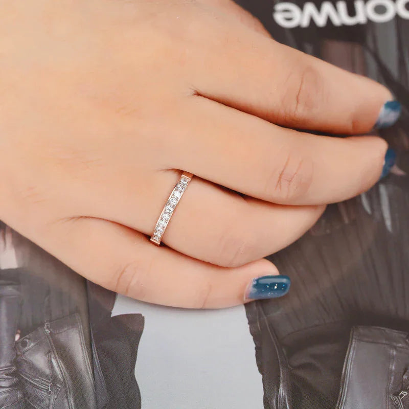 Rose gold crystal band ring worn on a finger