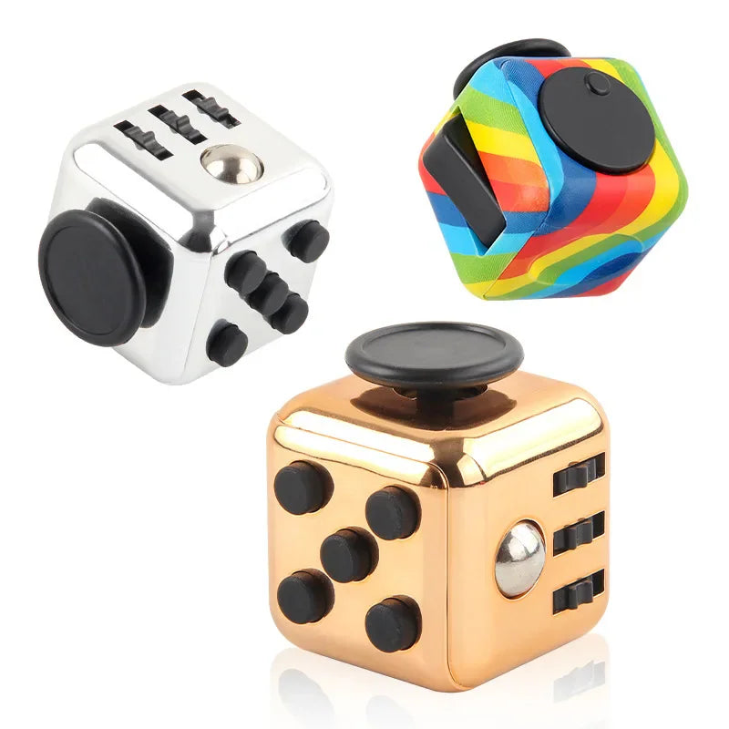 Three fidget cubes in silver, rainbow and gold metallic finishes.