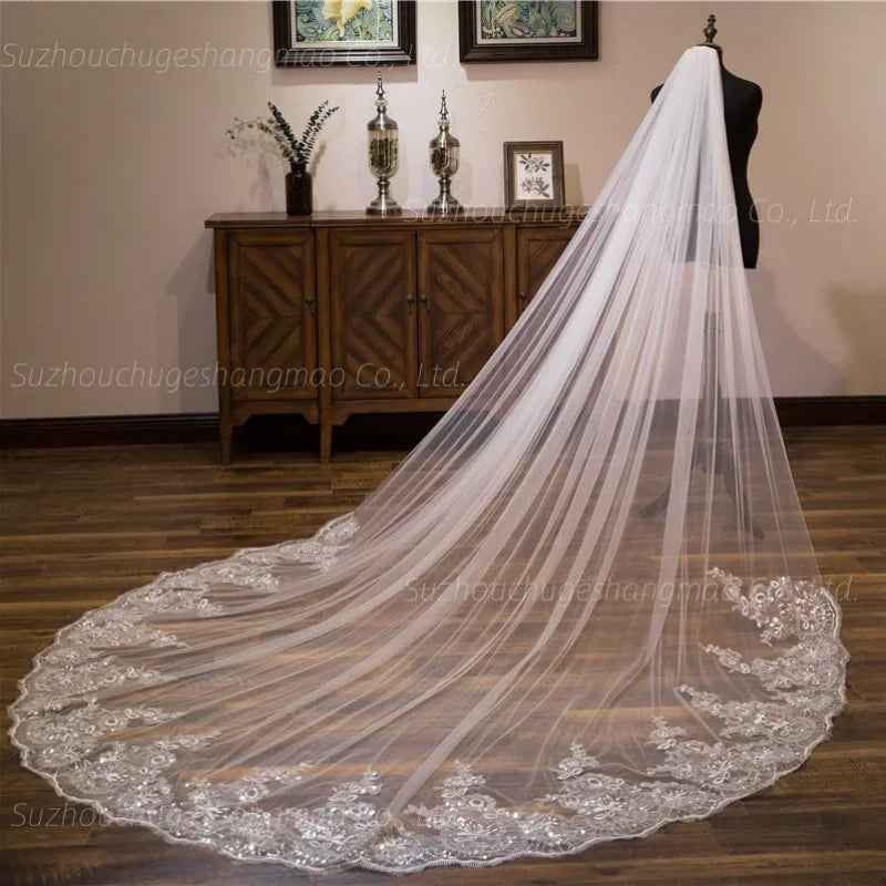 Long ivory cathedral wedding veil with lace floral appliques and bead embellishments on a mannequin, side view