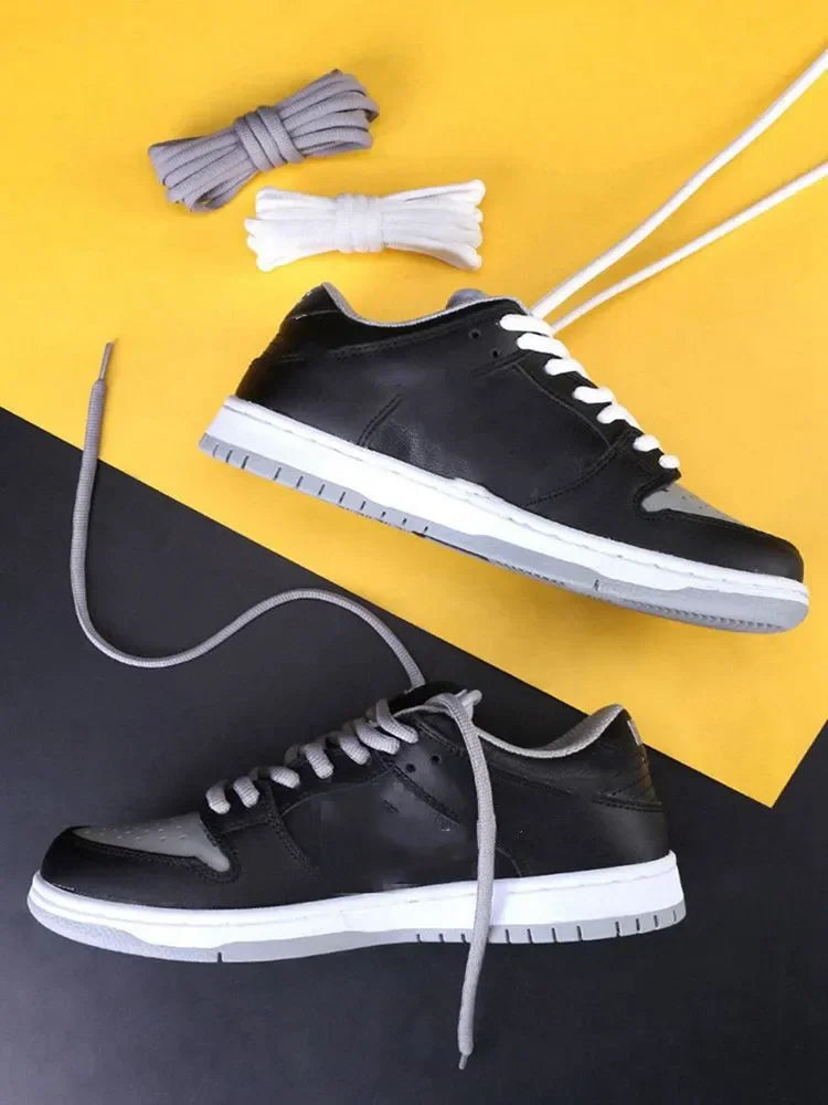 Two grey and black sneakers displayed with various replacement shoelaces in different colors.