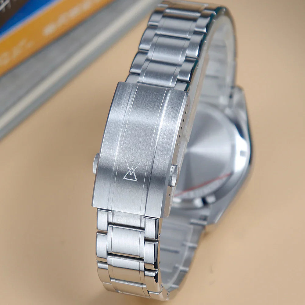 A close-up of the stainless steel deployment clasp on a watch bracelet with a subtle engraved logo.