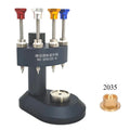 Watch hand installer tool with colored pins and a gold watch movement base