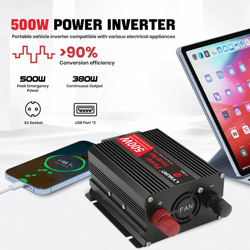 A black 500W power inverter charging a smartphone with a tablet visible nearby