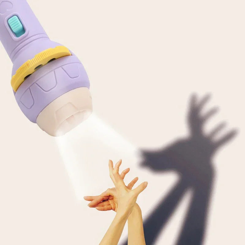 Hand holding a purple flashlight projector casting a shadow puppet on a wall