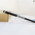 A black telescopic antenna with BNC connector next to a cardboard box.