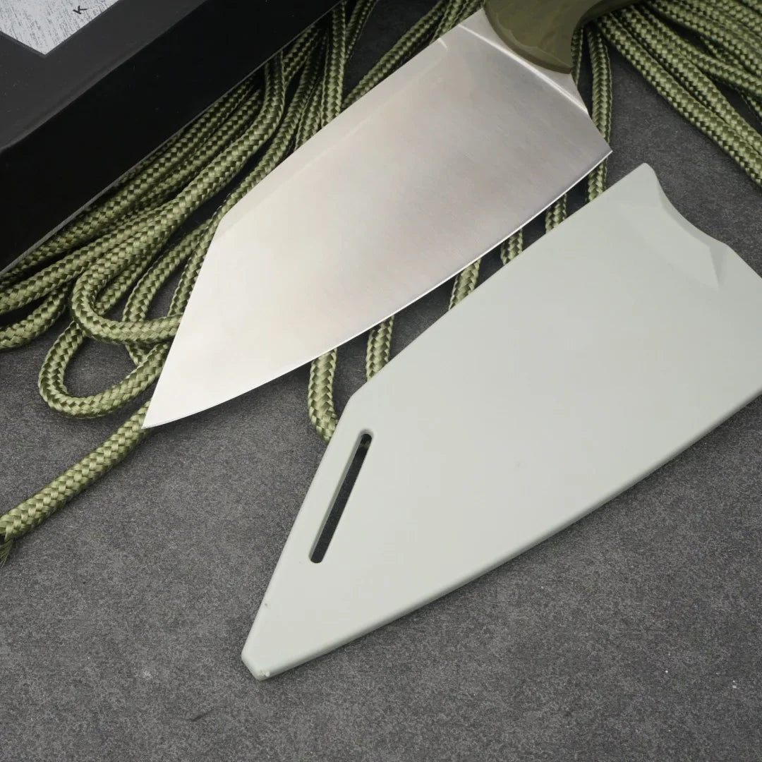 A stainless steel chef knife with an olive green and black micarta handle, lying next to a plastic sheath.