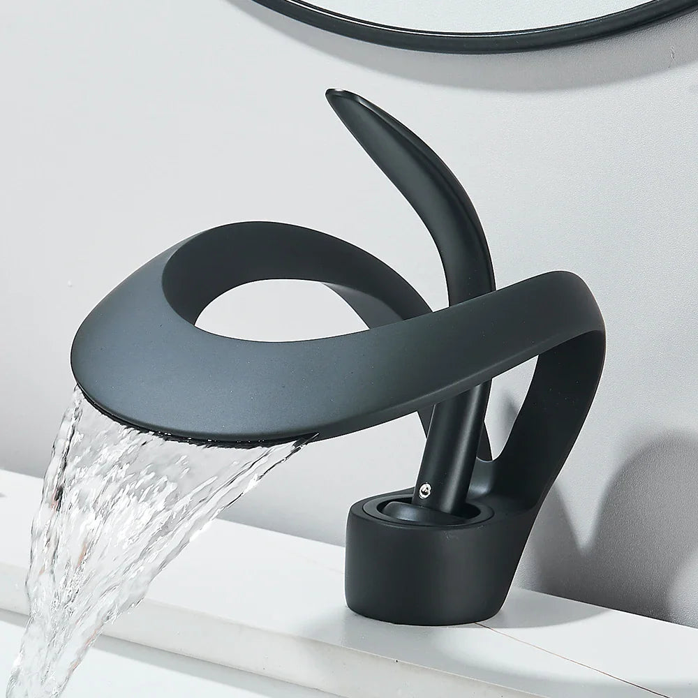 Modern matte black waterfall basin faucet with flowing water