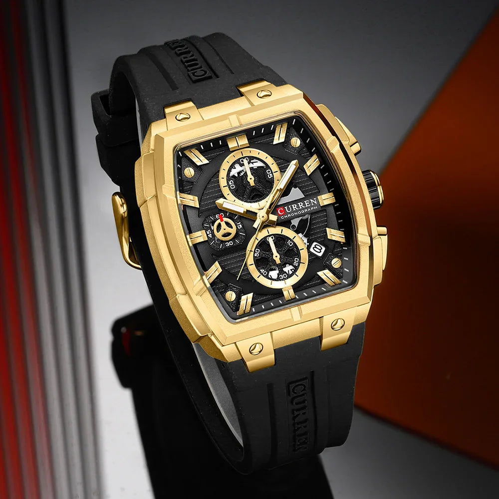 Men's square chronograph watch with gold case, black dial, and black silicone strap