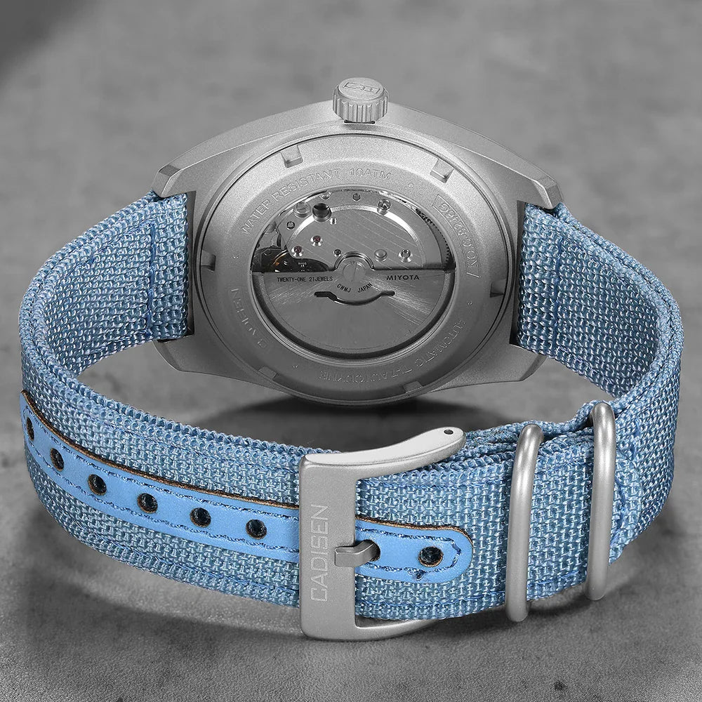 Titanium automatic watch with a blue canvas strap showing the case back and buckle