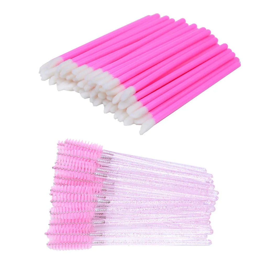 A collection of pink disposable microbrushes and eyelash spoolie wands.
