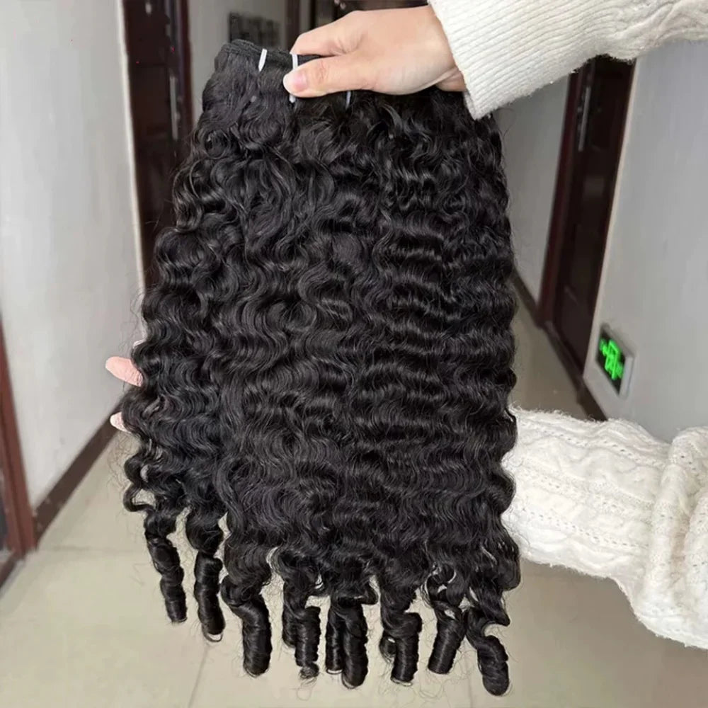 Hand holding a bundle of black deep curly hair extensions