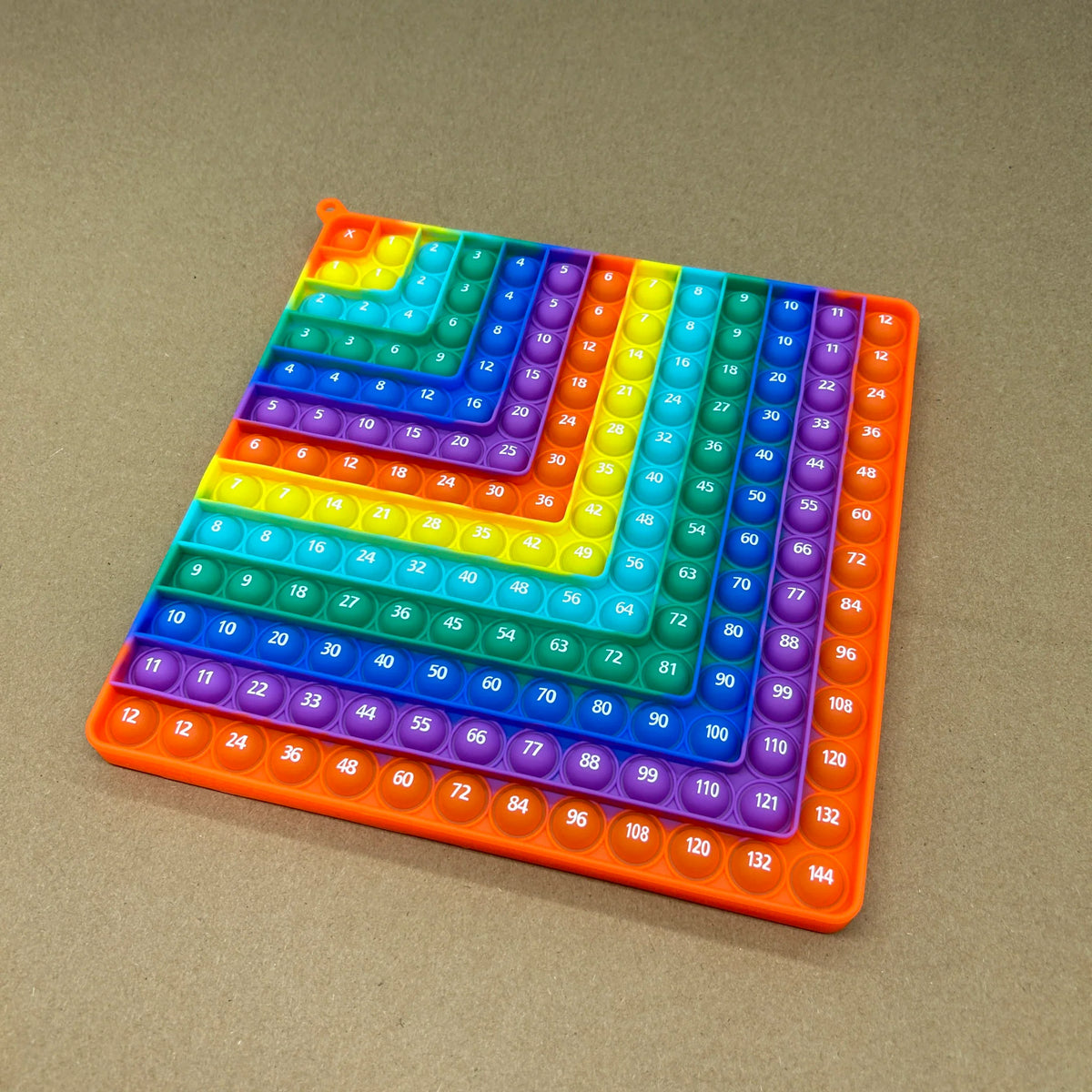 Rainbow colored 12x12 silicone multiplication board game with number pop bubbles