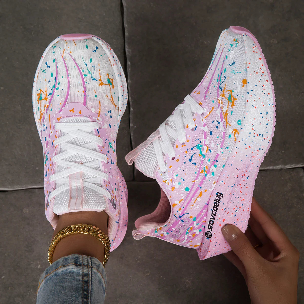 Pink and white paint splatter sneakers with a thick sole