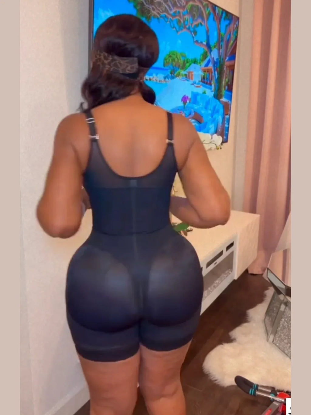Back view of black full body shaper bodysuit with lace leg hem