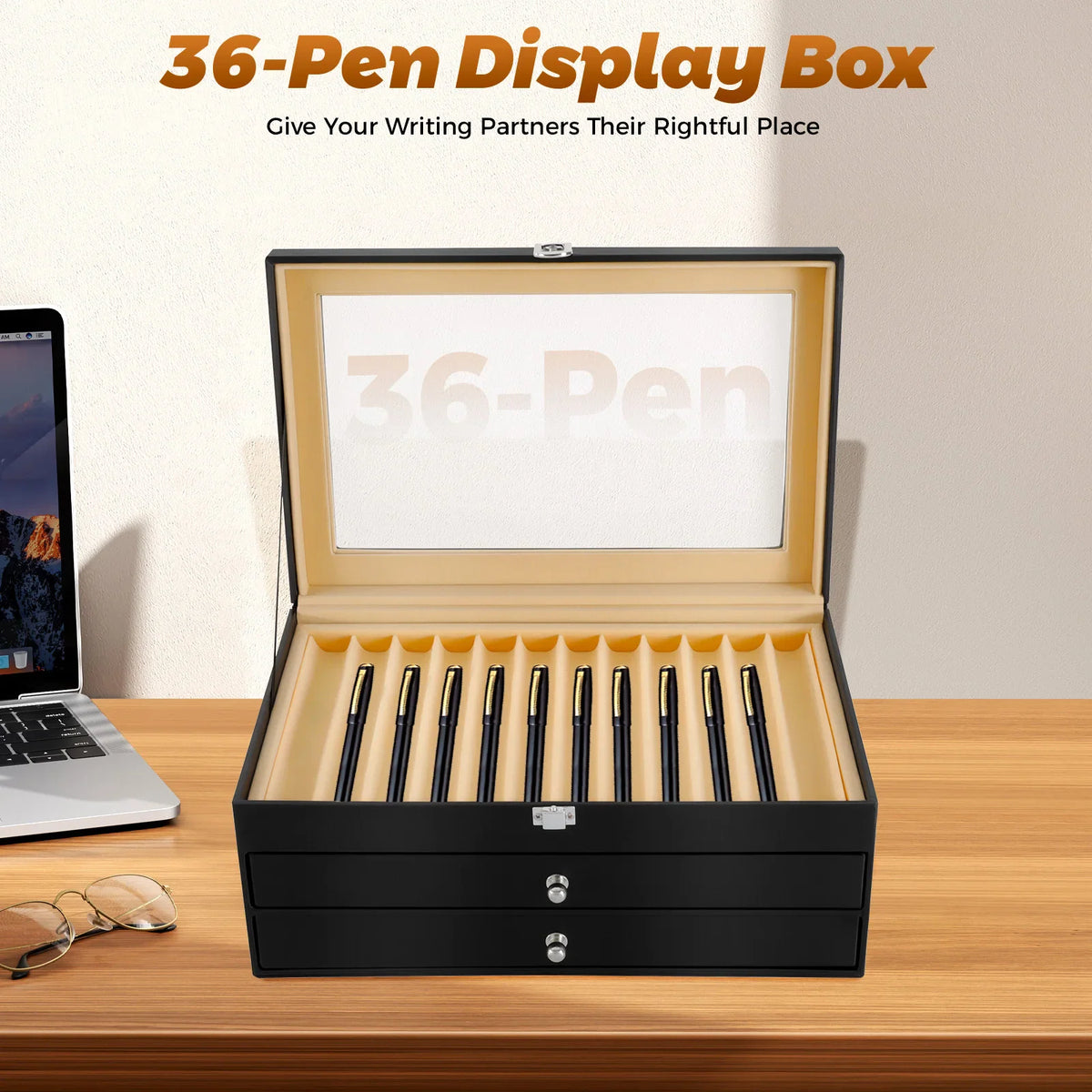 Black 36-slot pen display case with glass top on a desk with a laptop and eyeglasses.