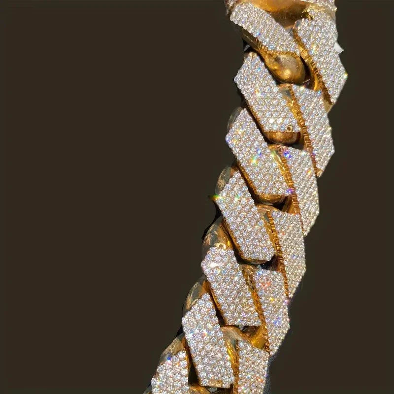 Close up detail of a gold tone Cuban link chain with pave set crystals
