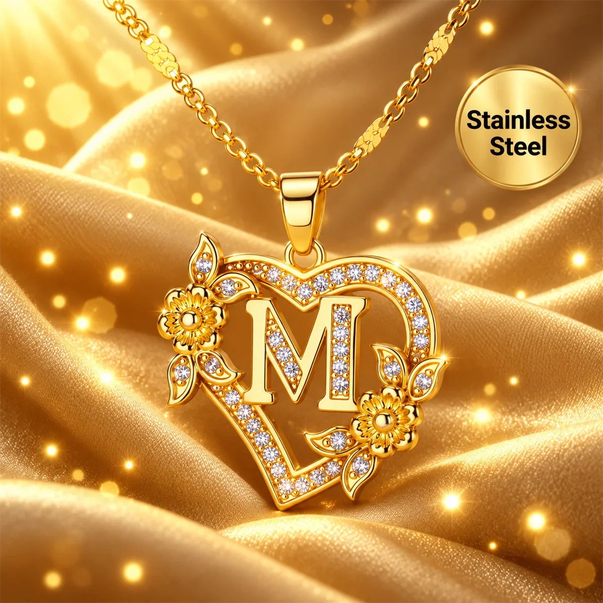 Single gold heart-shaped initial necklace with floral details on gold satin fabric