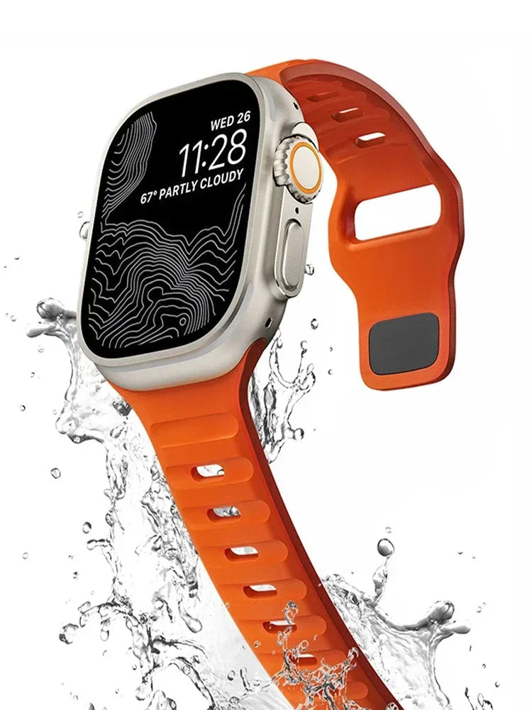 Orange silicone watch strap with rugged design, shown underwater.
