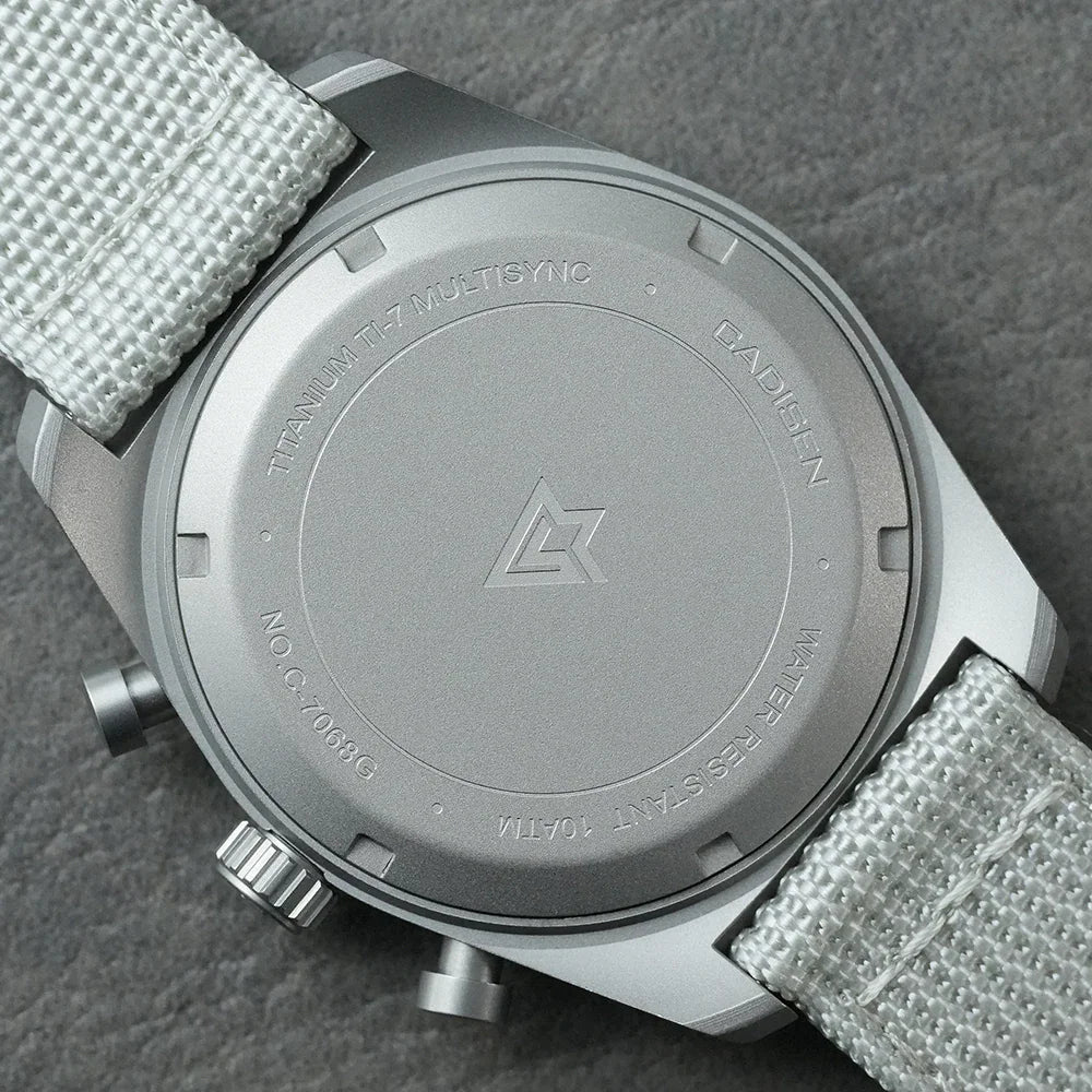 Case back view of a titanium chronograph watch with a white canvas strap