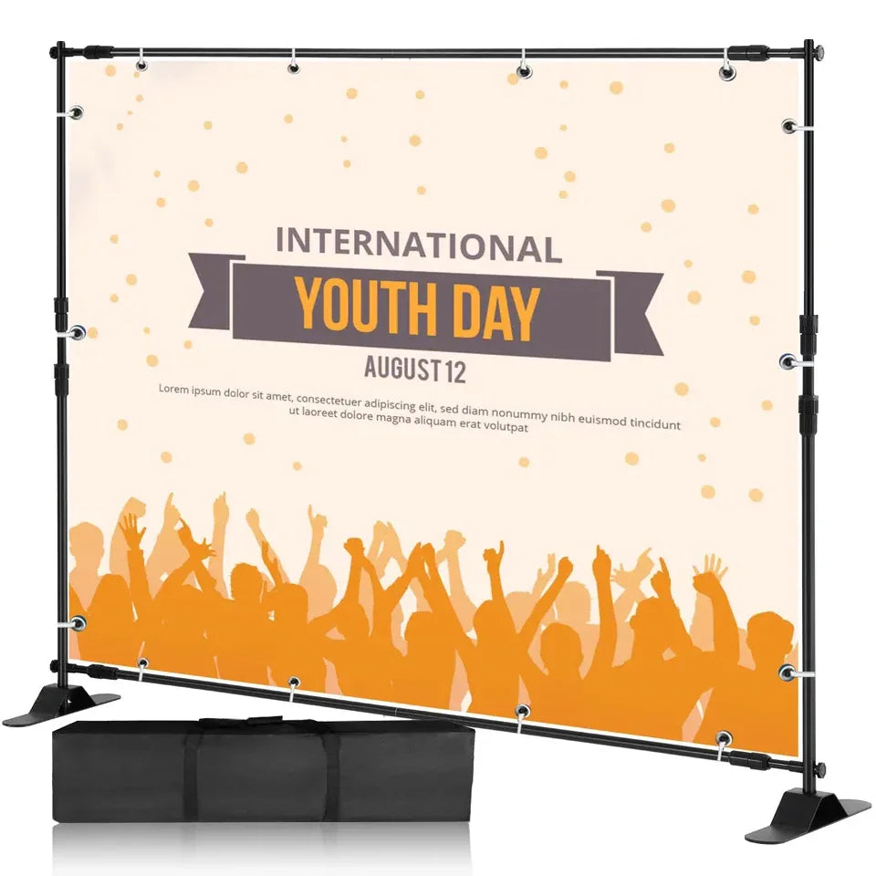 Adjustable black photography backdrop stand with an International Youth Day banner and carrying bag