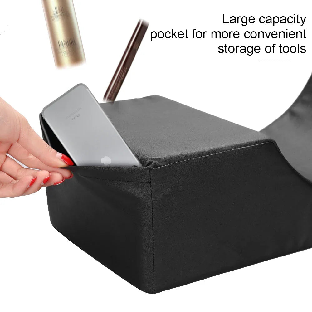 Black memory foam eyelash extension pillow featuring a side pocket being used to store a smartphone