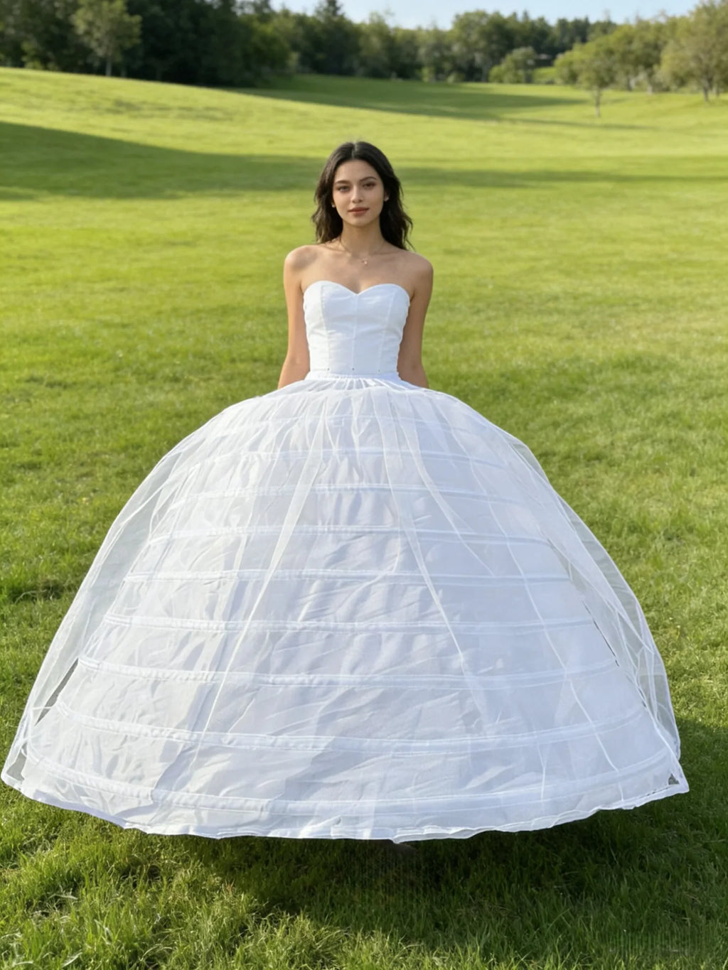 Woman wearing a white bridal ball gown with a voluminous ten-hoop petticoat