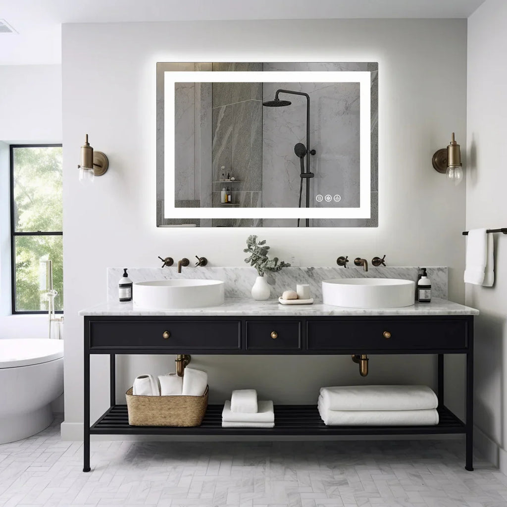 Modern rectangular LED backlit bathroom vanity mirror above a dark base double sink vanity