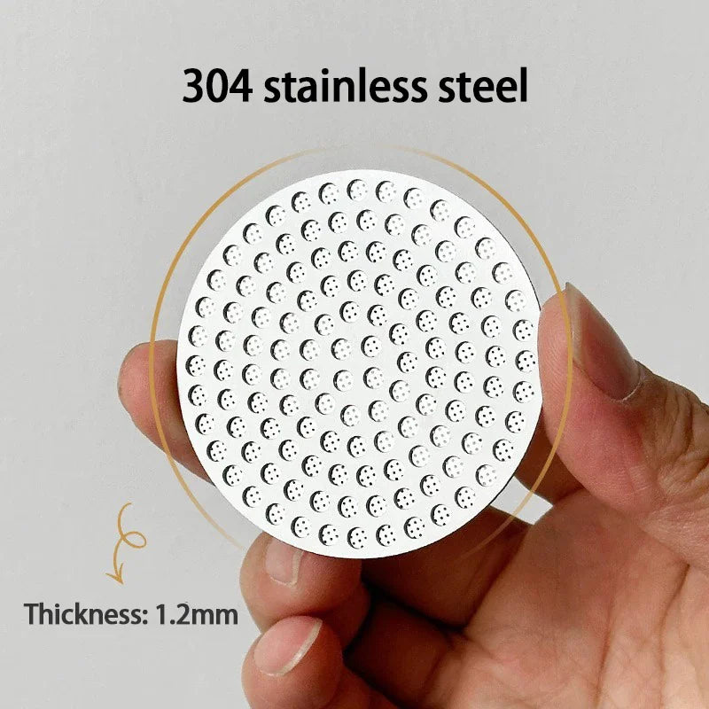 Hand holding a round stainless steel espresso puck screen