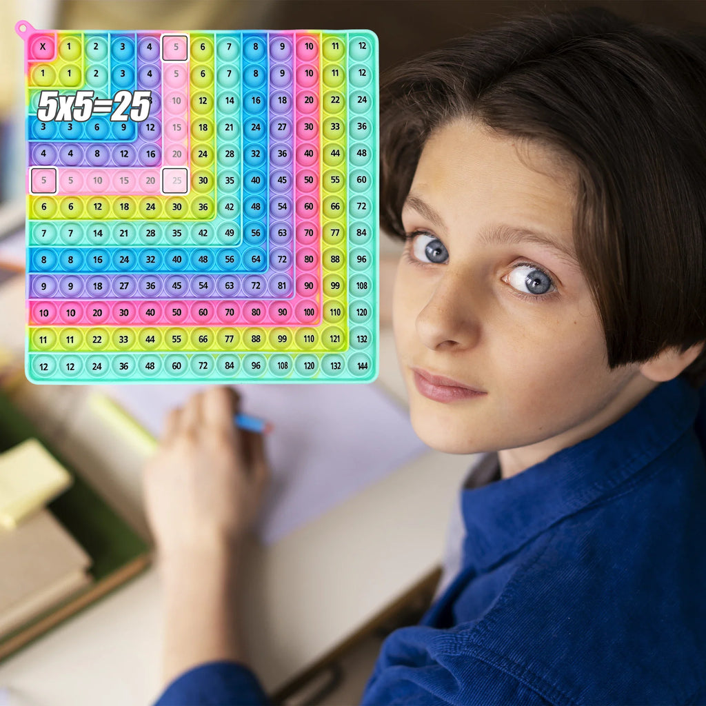 Rainbow colored 12x12 silicone multiplication board game used by a child
